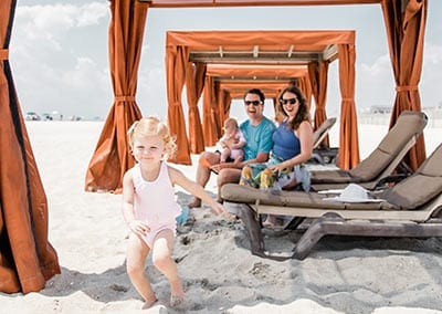 Happy family with kids inside beach cabana at Montreal Beach Resort
